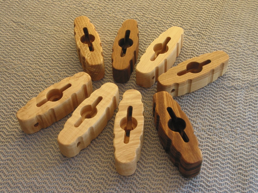 I have hand-made wing nut tools available that minimize wear and tear on weaver’s fingers, and marring of wing nuts and wood surfaces that can occur when pliers are used. The tool gives weavers the leverage needed to avoid hand-strain or the use of pliers to remove or tighten wing nuts (i.e., for changing out reeds in the beater or take-down / setup of some loom models). The tool simply fits over the top of the wing nut and protruding bolt, and you can easily loosen or tighten the nut. They have been popular with many weavers. The tool includes fluting around the edges for better grip and multiple coats of finish. The tool is $14 (plus shipping) in any of the four hardwoods shown in the photo (top row, left to right) - honey locust, black walnut, maple, or birch. -OR- $16 (plus shipping) in any of the four exotic hardwoods shown in the bottom row (left to right) - bird's eye maple, tiger (banded) maple (the 2 in the center), or koa. Specify a 2nd choice of hardwood in case I’m out of one of the types of wood. If you intend to use the tool on a Kessenich rug loom, let me know - the wing nuts are much larger and the tool requires larger openings. The tool will handle the majority of wing nut sizes found on weaving equipment (wing nut spans of 1" and greater). Dimensions of tool: 3” L, 1” W, 3/4” to 7/8” H, and slot to fit wing-nut is 1 1/2” L. Contact: jon16@hayman.us
