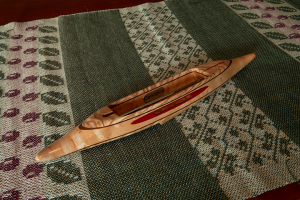 s2018exbashbemapl4: Ash burl top/bottom, black walnut 2nd layers, bird's eye maple center.  Pink ivory yarn slot inlay. 3.8 oz., 12 1/2″L, 1 3/4″W, 1 1/16″H, 3 5/8″ tip to nearest cavity end. Fits 4″ bobbins.