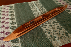 s2018dblkoamesq7:  Hawaiian koa top/bottom, mesquite center. Rosewood yarn slot and center divide  inlays. 6.5 oz., 18″L, 1 3/4″W, 1″H, 3 3/4″ tip to nearest cavity end. Fits two 4″ bobbins.